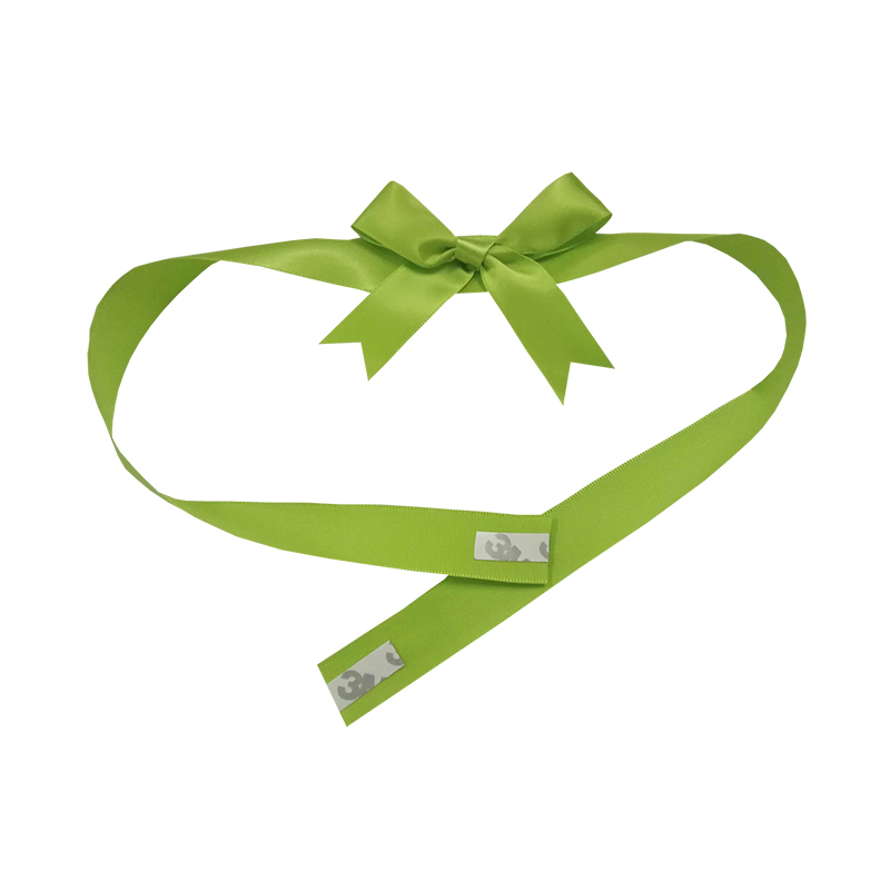 Satin ribbon gift bow with self-adhesive band on present
